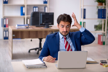 Young male employee working in the office