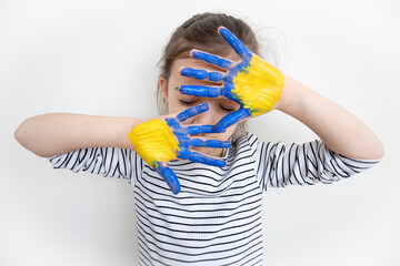 Child's hands painted on Ukraine flag colors.