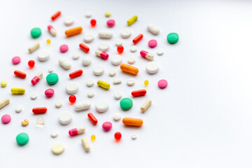 Creative layout of colorful pills and capsules on green background. Minimal medical concept. Pharmaceutical, Covid-19. Flat lay.Medication and prescription pills . Virus epidemic.