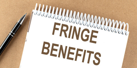 FRINGE BENEFITS text on a notepad with pen, business