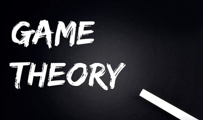 GAME THEORY Text on Black Chalkboard with a piece of chalk