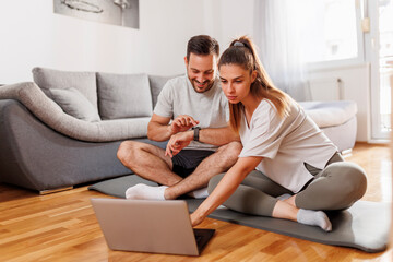 Couple getting ready for online workout at home