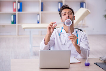 Young male doctor working in the clinic