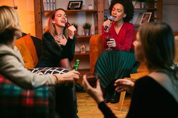 A multiracial friends having karaoke night at home.