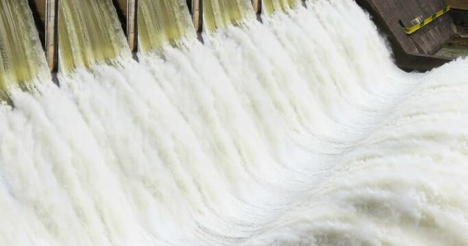 Hydroelectric power plant, river dam with flowing water at hydroelectric power station, force of water, renewable energy