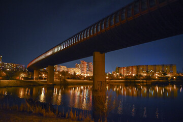 Subway tunnel leading across the lake, night urban landscape