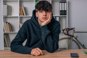 Fototapeta premium teenage boy at desk bored