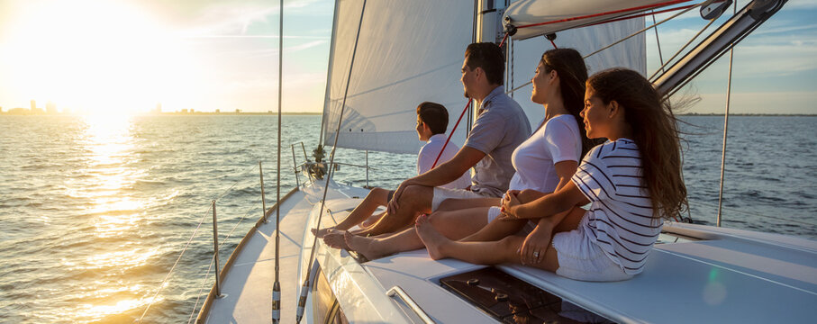 Panorama of Latin American family on sailing vacation at sunset