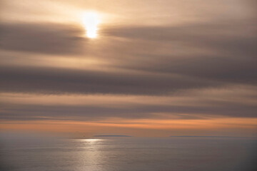 Naklejka na ściany i meble Sunset on the sea with a cloudy sky