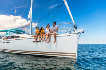 Happy Hispanic family relaxing together on private yacht