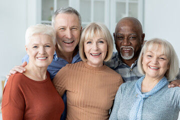 Portrait of multiracial group of senior people friends posing together