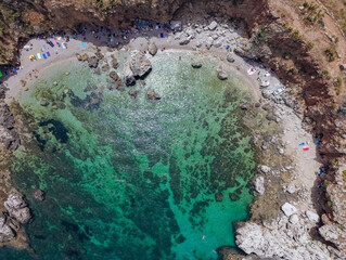 Drone aerial above beautiful coastline, turquoise clear sea water, wild nature, Zingaro Nature Reserve, Sicily. Tropical travel holiday near Scopello.
