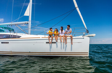 Latin American family relaxing together on luxury yacht