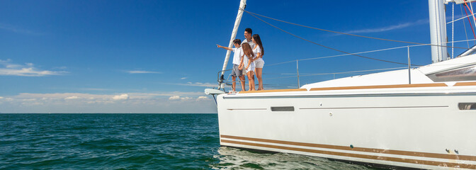 Panoramic Latin American family standing together on private yacht