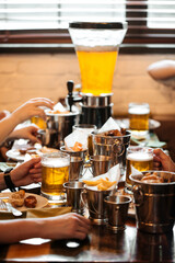 Table set with beer and salty snacks in a pub - obrazy, fototapety, plakaty