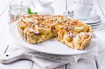 Traditional French apple tart aux pommes bouquet de roses served as close-up on classic design plate