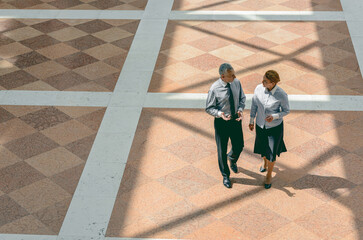 Above angle view of two business colleagues talking to each other