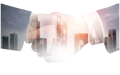 Shaking business hands on city background. Business and technology concept.