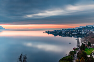 Reflex of the sky during beatiful sunset by the lake with the Alps in the background at Montreux Switzerland