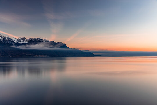 Reflex of the sky during beatiful sunset by the lake with the Alps in the background at Montreux Switzerland