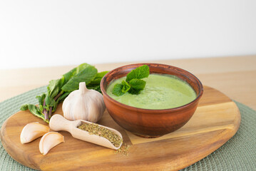 Tasty green chutney sauce. With fresh mint pudina and yogurt. Spicy indian cuisine. Served on brown...