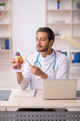 Young male doctor cardiologist working in the clinic