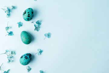 Obraz na płótnie Canvas Border made of Easter quail eggs with hydrangea flowers, Easter greeting card.