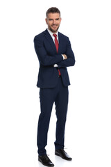 businessman crossing his arms, smiling at the camera