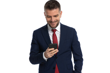 businessman looking at the phone and feeling pleased