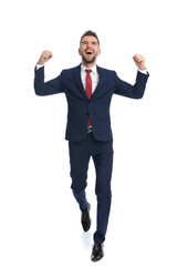 businessman walking towards the camera and celebrating success
