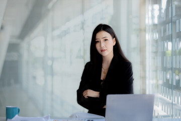 Asian women sitting in the office, young Asian business women as business executives, founding and running start-up executives, young female business leaders. Startup business concept.