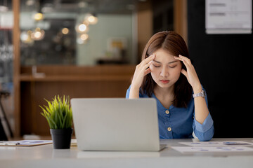 Beautiful Asian woman working in an office, she is a businesswoman who owns a company, she has a...