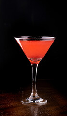 cosmopolitan cocktail in martini glass on wooden table front view - obrazy, fototapety, plakaty