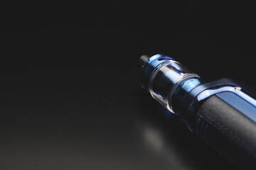 Electronic cigarette on black background, vape, smoking concept