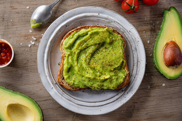 Tasty fresh toast with mashed avocado