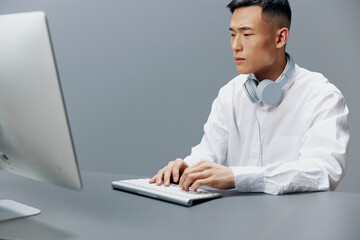 businessmen in a white shirt with headphones sits in the office Lifestyle work
