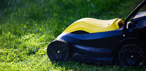 mowing the grass with a lawn mower. Garden work concept background