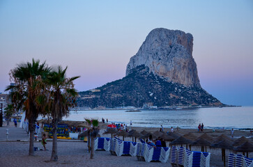 View over Calpe beach to the Penyal d'Ifac rock in the Mediterranean Sea in the evening light of...