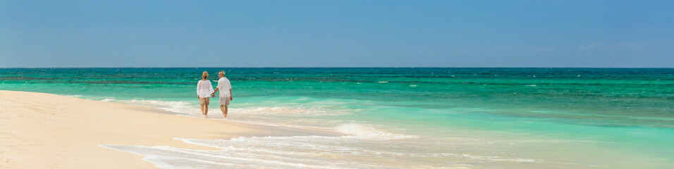 Panoramic retired couple by ocean at island resort
