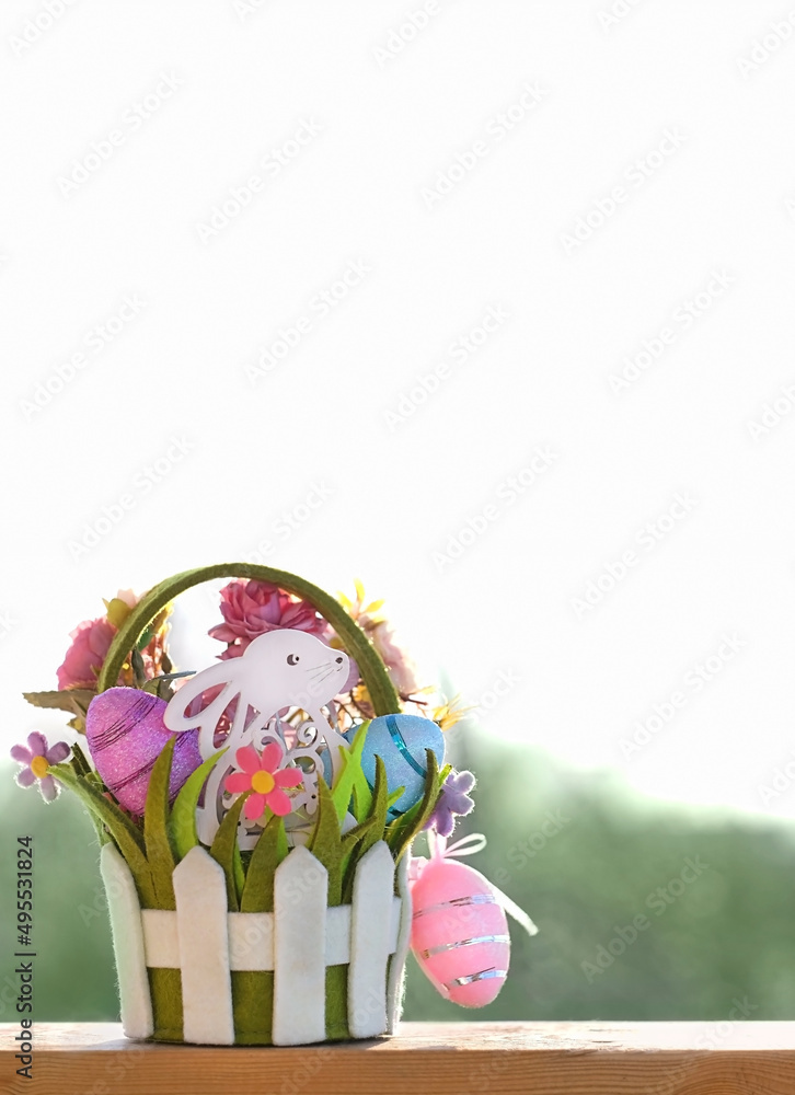 Wall mural easter bunny with eggs and flowers in basket, abstract light natural background. easter holiday. dec