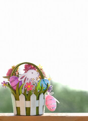 Easter Bunny with eggs and flowers in basket, abstract light natural background. Easter Holiday. decorative festive composition. spring season. copy space