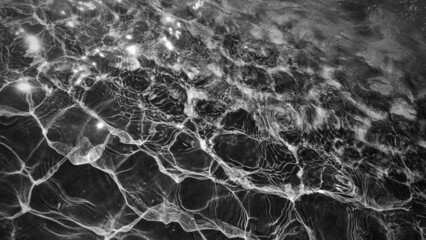 Waves on the water close-up. Black and white photo
