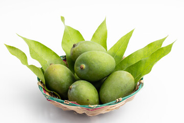 Closeup Of Fresh Raw Green Mangoes Also Called Kacha Khatta Aam With Leaves In Bamboo Basket. Isolated On White Background With Copy Space