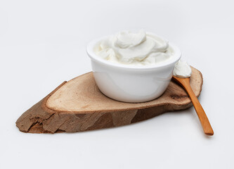 a bowl of yogurt on a wooden plank - 495533849