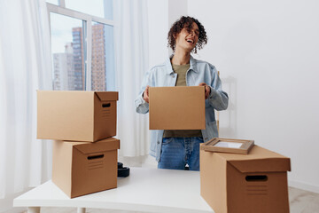 portrait of a man unpacking with box in hand Lifestyle