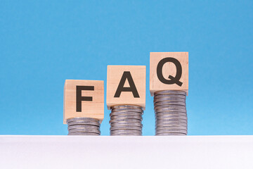 FAQ - text on wood cube block stack with coins