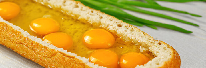 huge sandwich with raw eggs inside. Stuffed big ciabatta bread with raw ingredients ready to bake in the oven. the process of making pie or snacks. close up
