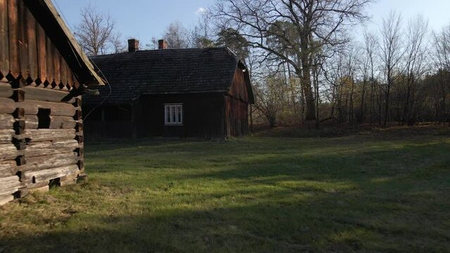 Old wooden farm houses with spring green landscape