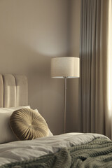 Stylish floor lamp near bed in room. Interior element