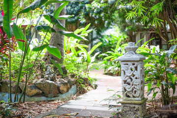 path in a tropical park. Tropical plants and decorative elements, selective focus. Travel and tourism, landscape design.